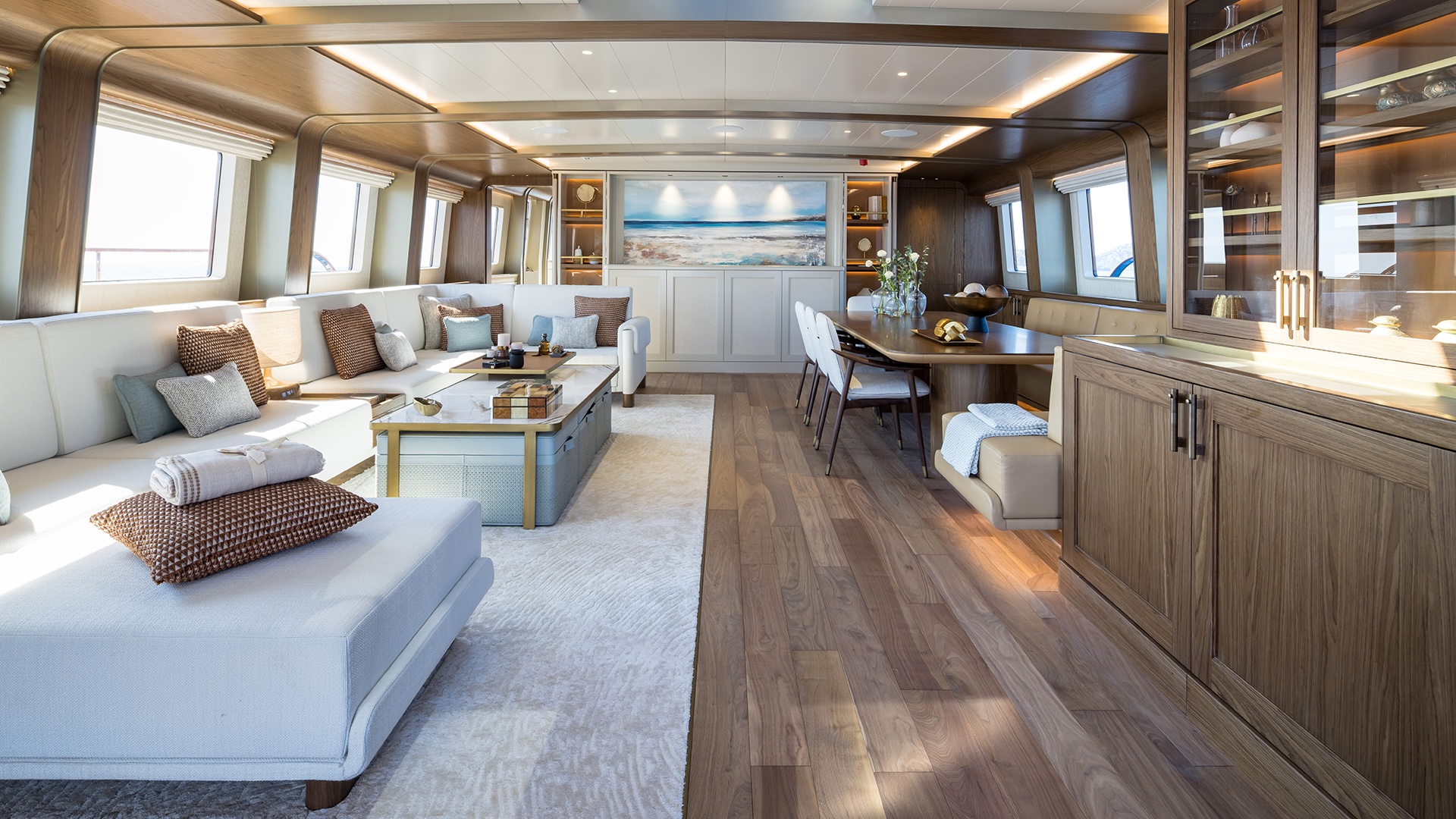 Main salon on the ARES Simena 62m sailing yacht with darkened oak panelling and brass detailing