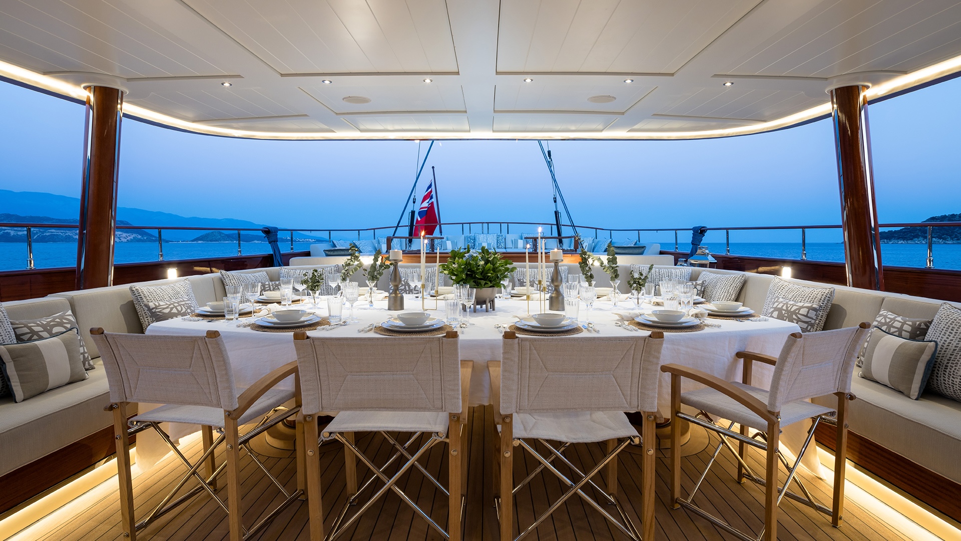 Outdoor dining on the aft cockpit of Simena with mahogany tables