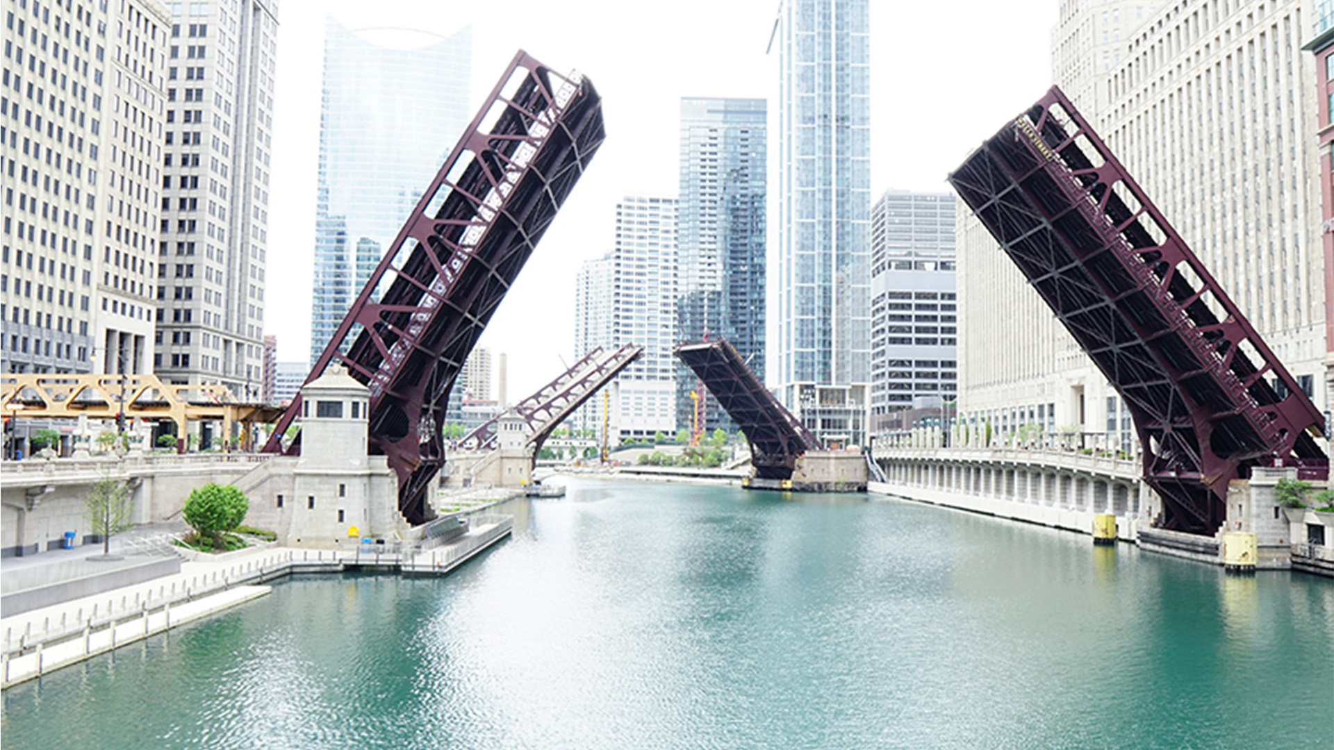 Two consecutive bridges opening over an urban waterway