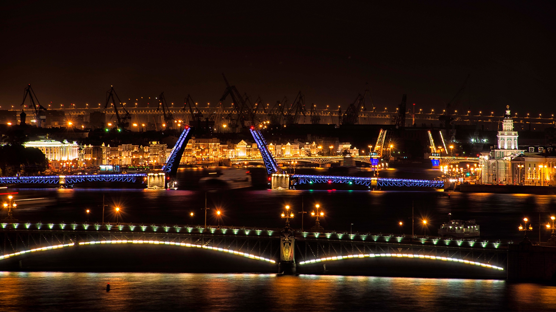 A drawbridge raised at night, viewed from the water in St Petersburg, Florida