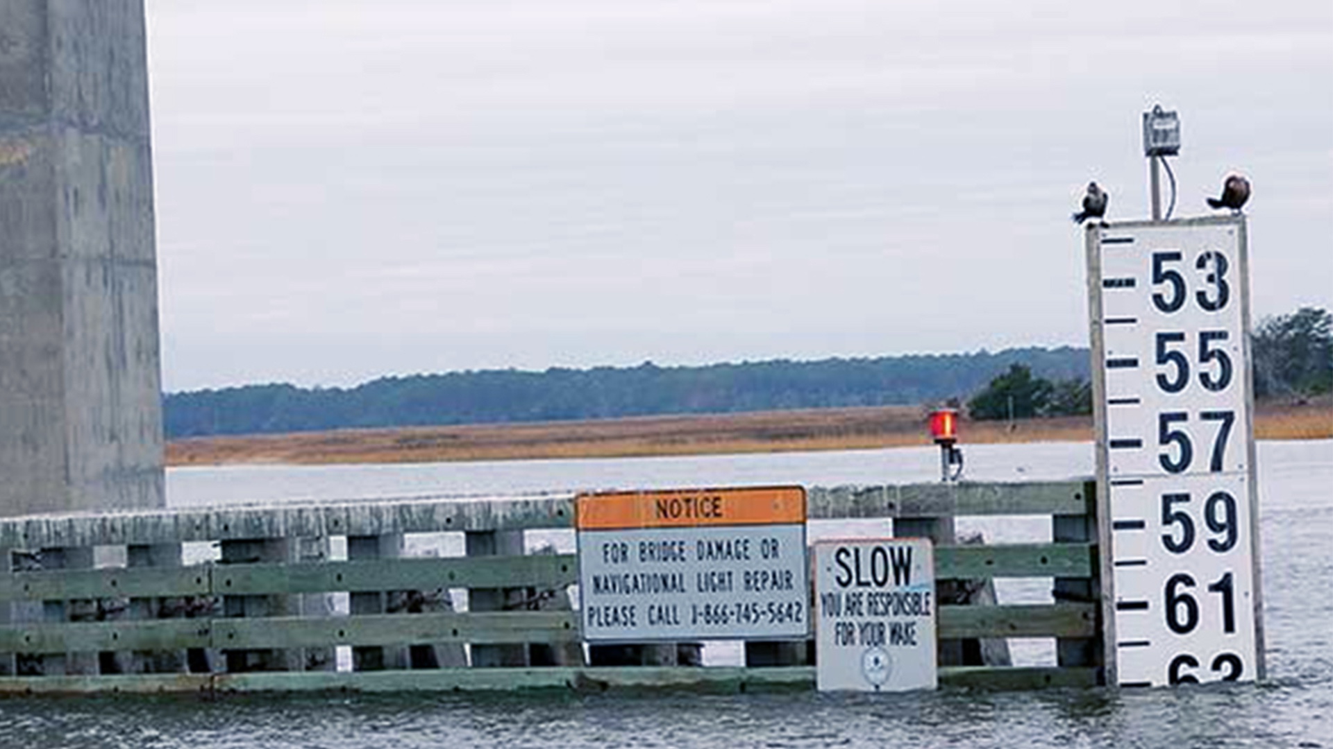 Bridge clearance gauge mounted on the abutment, viewed from the water