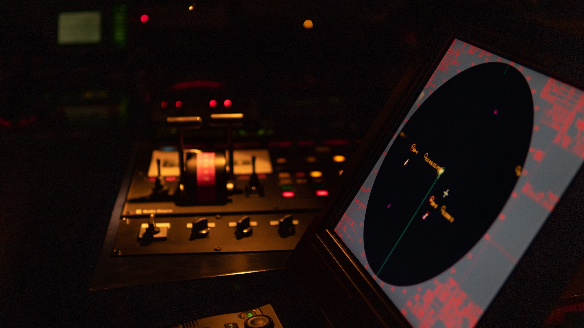 Radar screen at the interior helm of a yacht, at night