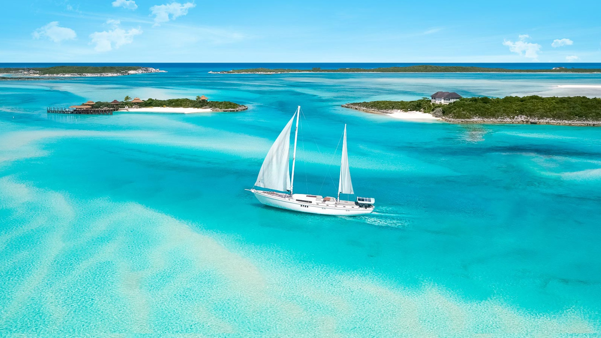 Aerial view of a large sailboat among the Bahamian islands