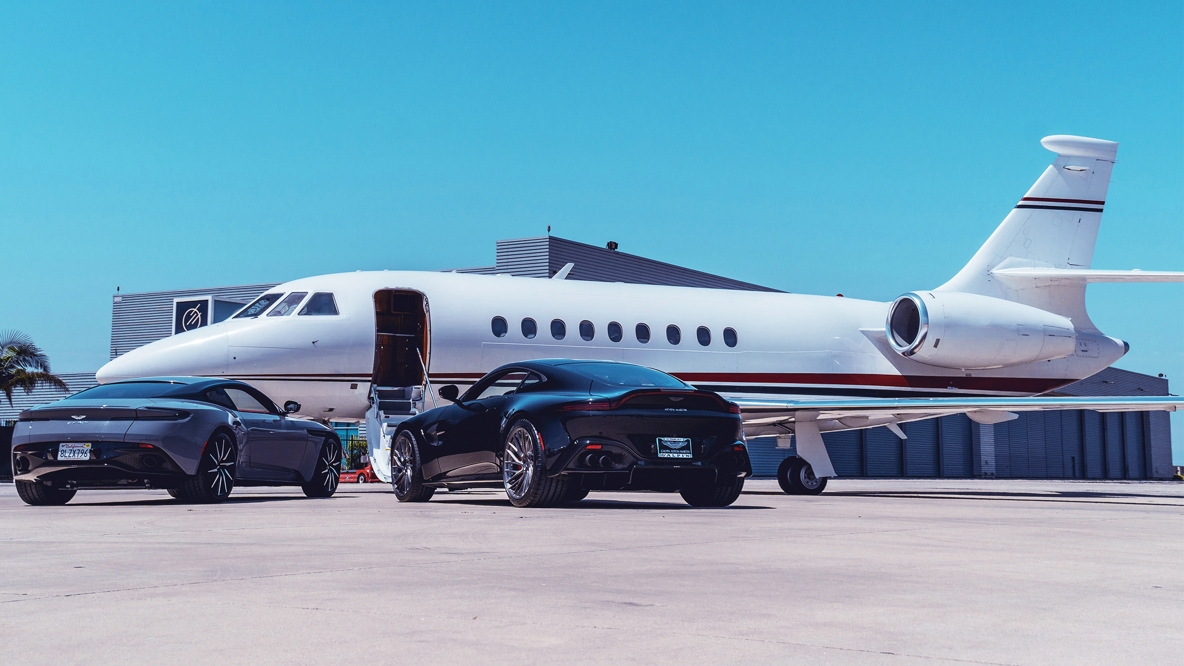 Private aircraft on the apron with airstair open and cars waiting