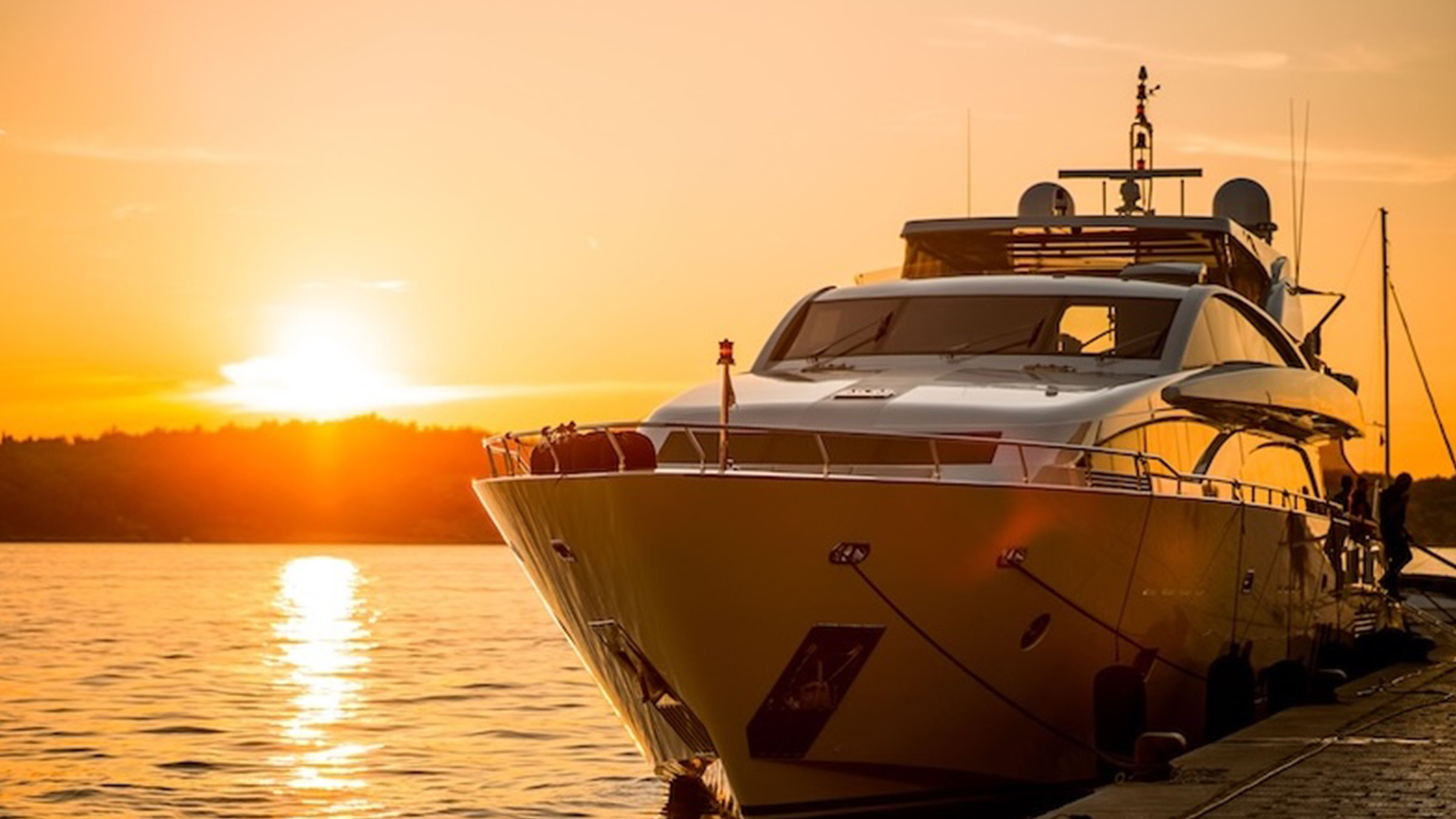 Boat at sunset, crew prepared with lifejackets aboard