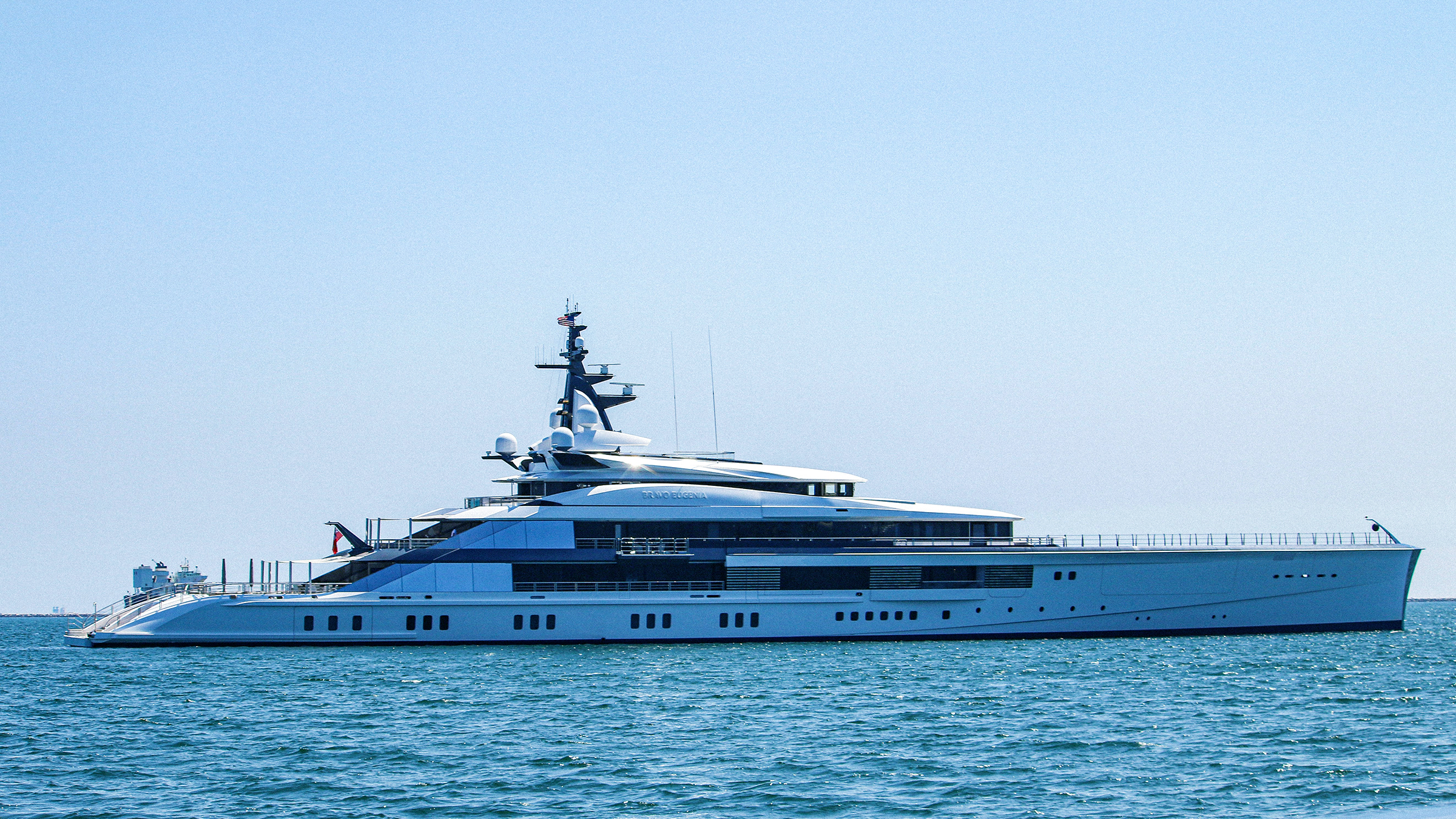Yacht anchored on blue water awaiting arrival